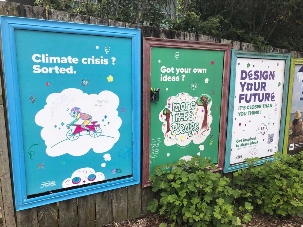 People drawing on Design Your Future campaign posters